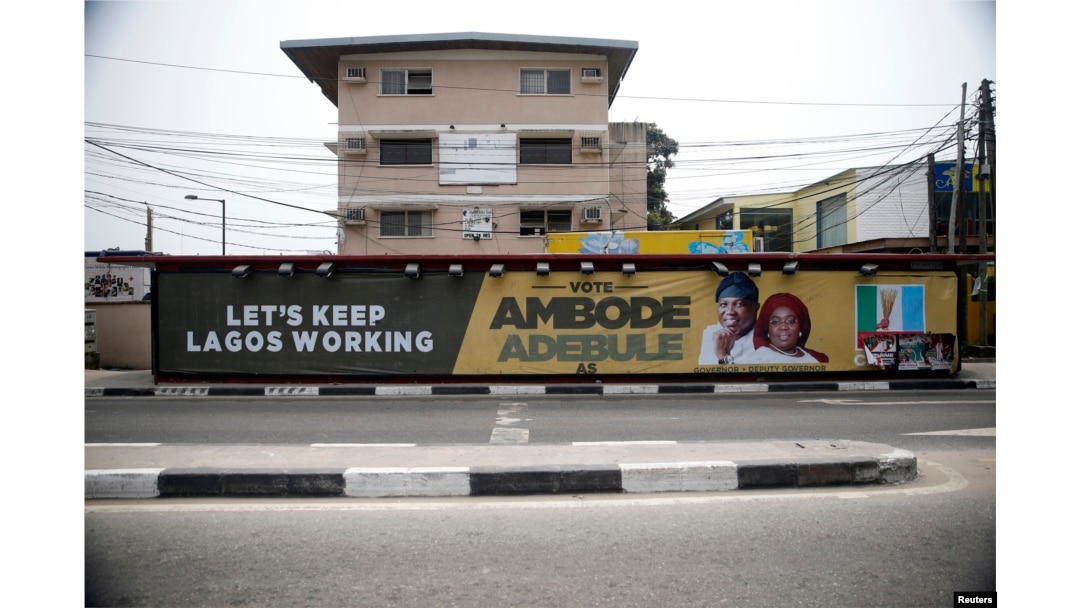 A campaign banner in support of the opposition All Progressives Congress (APC) governorship candidate Akinwunmi Ambode and his running mate, Oluranti Adebule, is seen along a road in Ikoyi district in Lagos, Feb. 13, 2015.