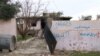 The word “Daeshy,” meaning IS militant, is scrawled on a burnt-out house once belonging to a militant in a village outside of Mosul city in Iraq, Nov. 27, 2018.