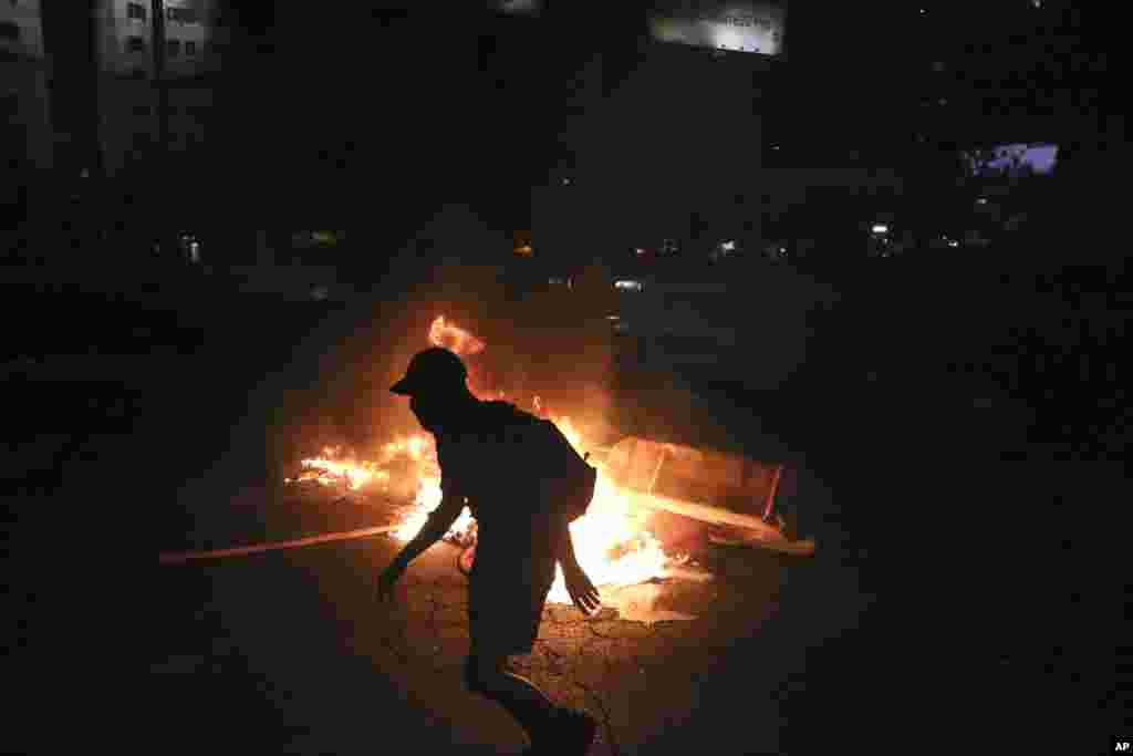 Demonstrators clash with police, after the death of Mapuche indigenous man Camilo Catrillanca during a police operation in La Araucania region of the country, in Santiago, Chile, Nov. 15, 2018.
