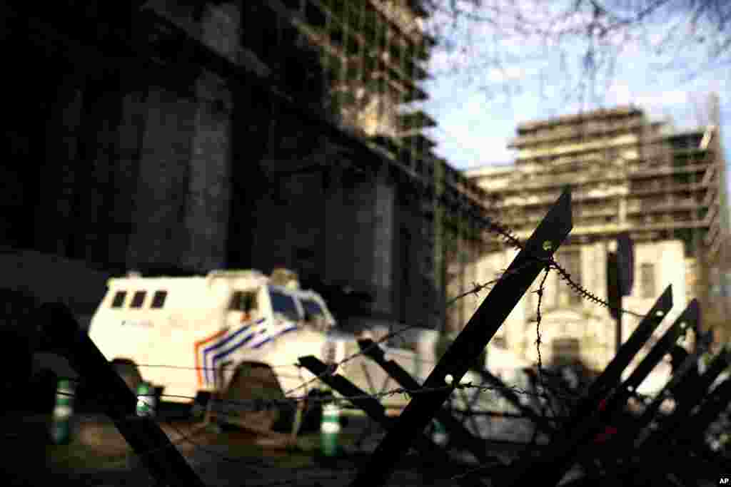 An armored police vehicle and barbed wire fence block the way outside the Justice Palace during the trial of Mehdi Nemmouche in Brussels, Belgium. Nemmouche is charged with 'terrorist murder' over the killing of an Israeli couple and two staffers at the Brussels Jewish Museum.