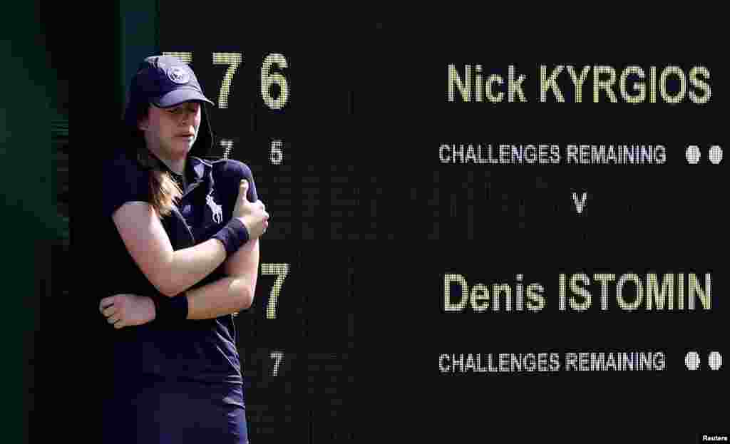 A ball girl reacts after she was hit by a serve from Australia's Nick Kyrgios during the first-round match against Uzbekistan's Denis Istomin at the Wimbledon Tennis Championships in London.
