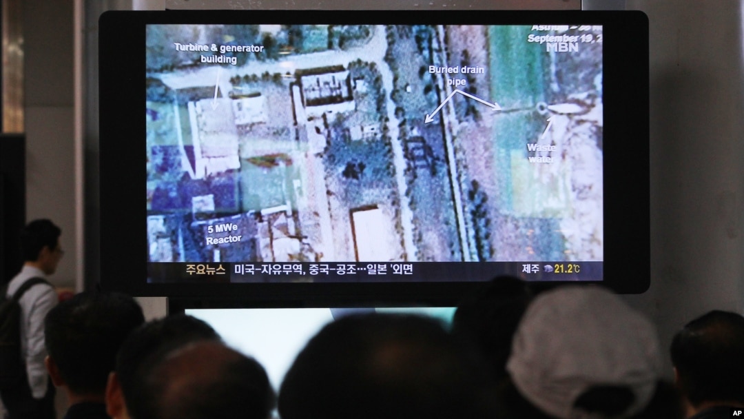 FILE - South Koreans watch a television broadcasting a satellite image of the nuclear facility in North Korea, at the Seoul Railway Station in Seoul, South Korea, Oct. 8, 2013.