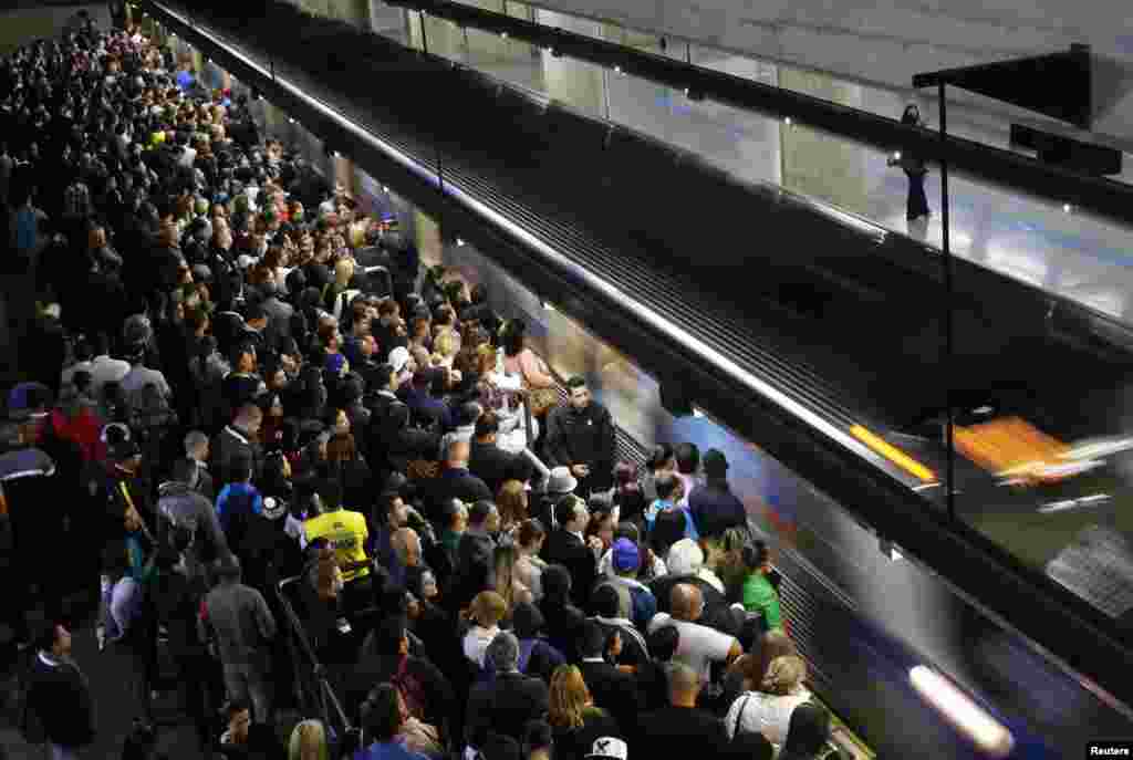 Commuters wait for the train at the Estacao da Se subway station in downtown Sao Paulo. Subway workers suspended a strike on Monday that crippled traffic in Brazil's largest city, but warned they could resume their walkout on Thursday, when Sao Paulo hosts the first game of the World Cup, June 10, 2014.