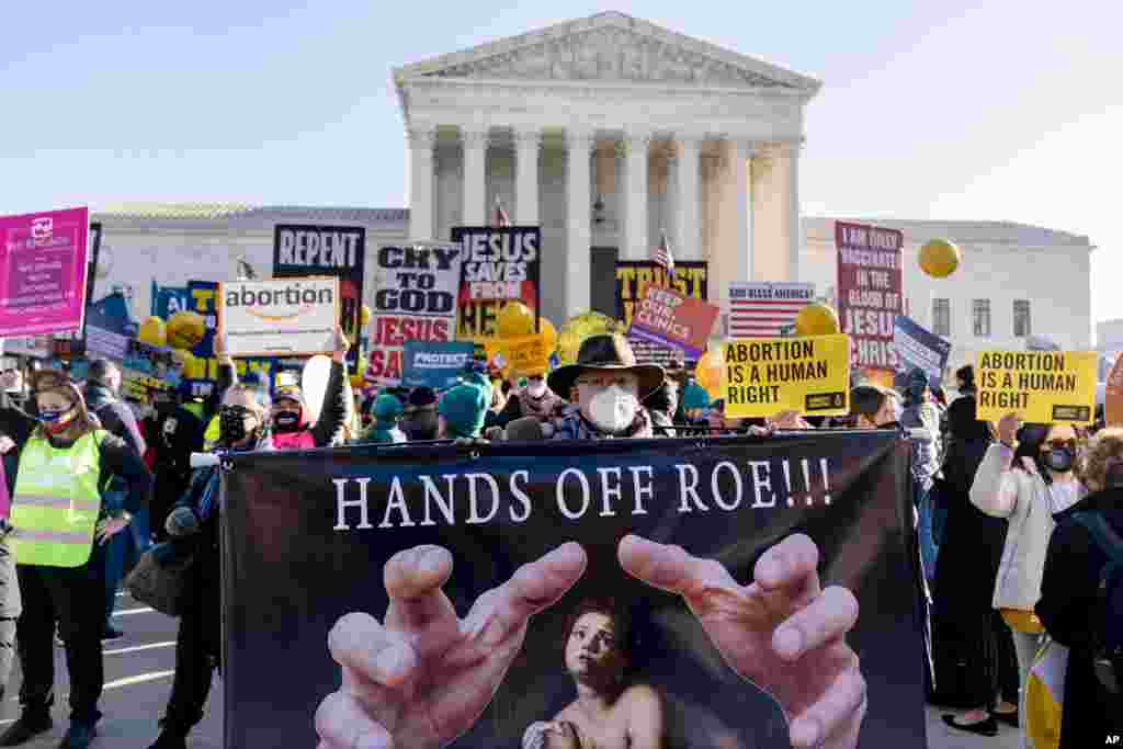 Abortion rights advocates and anti-abortion protesters demonstrate in front of the U.S. Supreme Court in Washington, as the court hears arguments in a case from Mississippi, where a 2018 law would ban abortions after 15 weeks of pregnancy, well before viability. 
