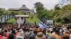 Protesters gather outside the parliament building in Honiara, Solomon Islands, Nov. 24, 2021, in this screen grab obtained by Reuters, from a social media video. (Georgina Kekea via Reuters)