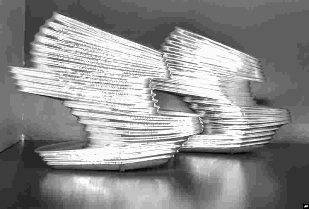 FILE - A pair of 2013 chromed vinyl shoes by designer Zaha Hadid are on display at an exhibit at the Brooklyn Museum in New York, Sept. 4, 2014. 'Killer Heels: The Art of the High-Heeled Shoe' highlights shoes from the 1600s to the present.