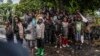 FILE - Congolese children watch the deployment of government and U.N. troops outside Goma, Democratic Republic of Congo, Jan. 24, 2025, as M23 rebels are reported to be closing in on the town. 
