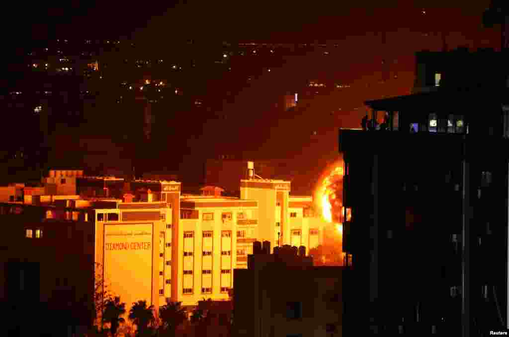 Flame and smoke are seen during an Israeli air strike in Gaza City in the Gaza Strip, following a rocket strike on Tev Aviv that damaged a house and injured several people.