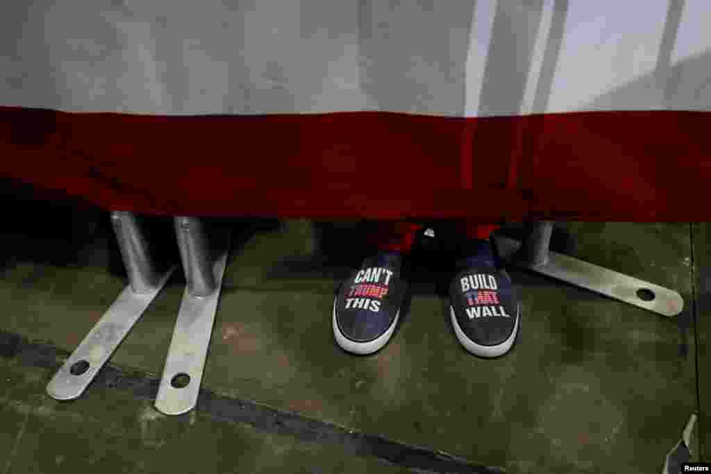 A rallygoer's shoes are seen during a campaign rally with U.S. President Donald Trump in Estero, Florida, Oct. 31, 2018.