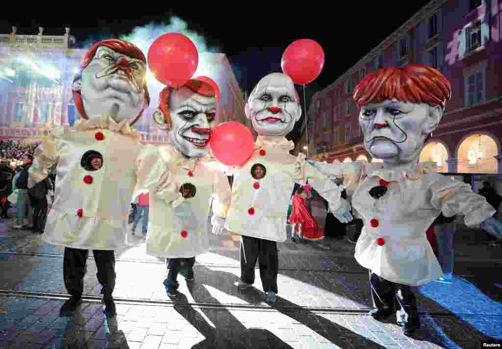 Giant figures of French President Emmanuel Macron, German Chancellor Angela Merkel, U.S. President Donald Trump and Russian President Vladimir Purin are seen during the 135th Carnival parade in Nice, France.