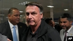 Former Brazilian President Jair Bolsonaro arrives for a luncheon with senators from his support base, at the National Congress building in Brasilia, Brazil, Feb. 18, 2025. 