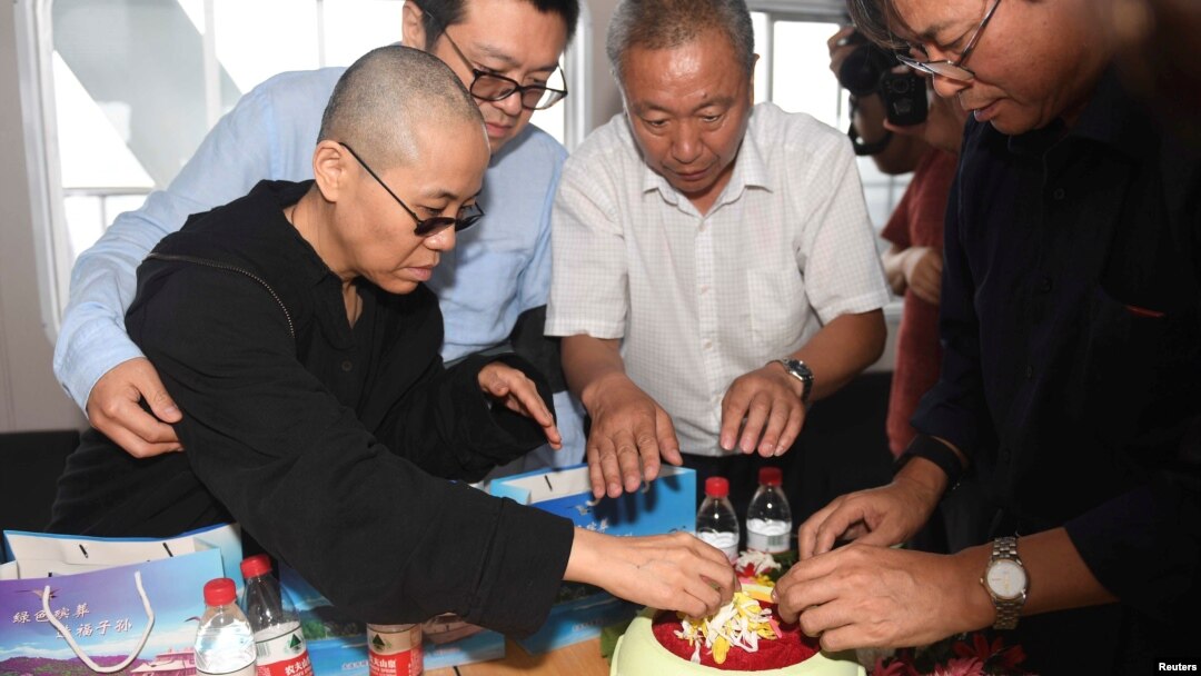 Liu Xia, wife of deceased Chinese Nobel Peace Prize-winning dissident Liu Xiaobo and other relatives attend his sea burial off the coast of Dalian, China, in this photo released by Shenyang Municipal Information Office July 15, 2017. 