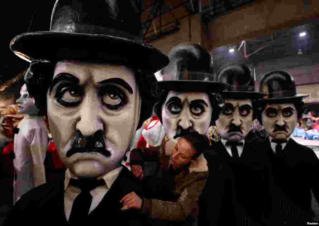 A worker checks a figure of Charlie Chaplin during preparations for the carnival parade in Nice, France.