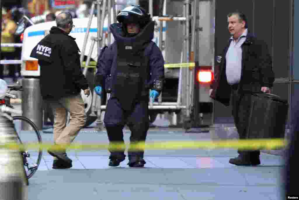 A member of the New York Police Department bomb squad is seen outside the Time Warner Center in the Manhattan borough of New York City after a suspicious package was found inside the CNN Headquarters.