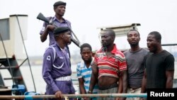 Suspected pirates are paraded aboard a naval ship after their arrest by the Nigerian Navy at a defense jetty in Lagos, August 20, 2013. 