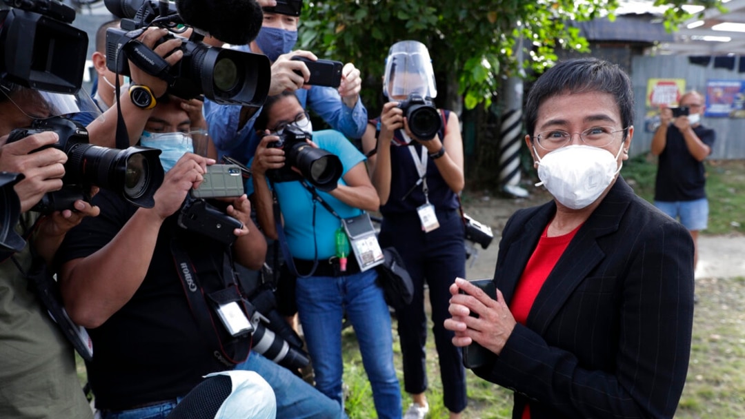 FILE - Rappler CEO Maria Ressa stands in front of reporters outside the Court of Tax Appeals in Manila, Philippines, March 4, 2021.