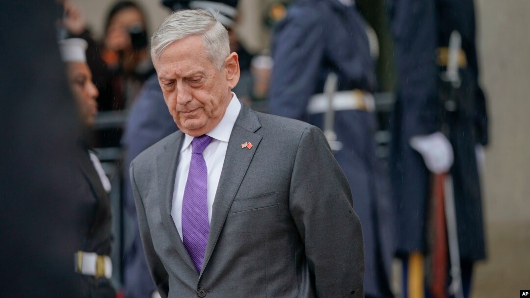 FILE - Defense Secretary Jim Mattis waits for Chinese Minister of Defense General Wei Fenghe to begin an arrival ceremony at the Pentagon, Nov. 9, 2018.