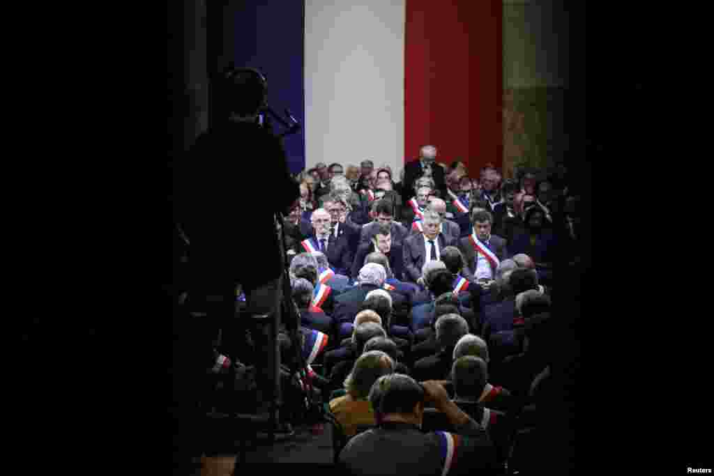 French President Emmanuel Macron looks on during a meeting attended by some 600 mayors of Occitania to relay their constituent's grievances, in Souillac, France.