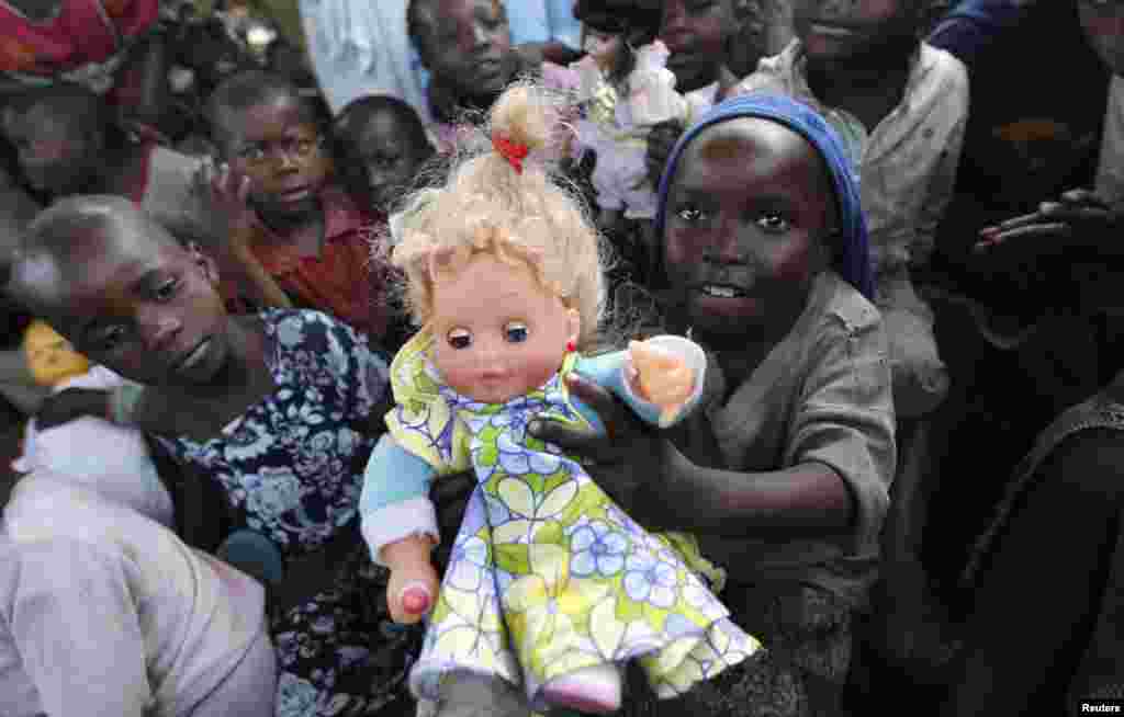 A Congolese girl, displaced by recent fighting in North Kivu, holds a doll at the child friendly space (CFS) within Mugunga III camp for the internally displaced people near Goma, eastern Democratic Republic of Congo.