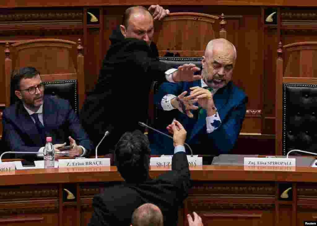 Albania's Prime Minister Edi Rama reacts as ink is thrown at him by members of the opposition during parliamentary session in Tirana.