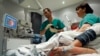 FILE - A doctor performs a colonoscopy on a patient at the Ambroise Pare hospital in Marseille, southern France.