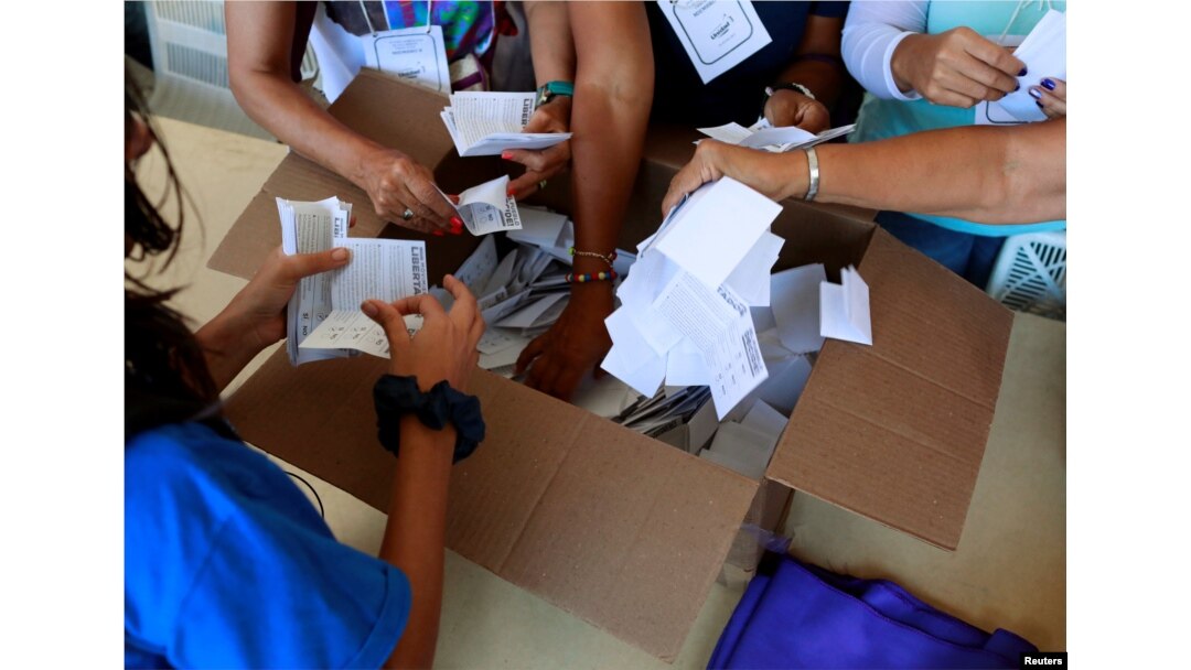 Opposition supporters count votes at a polling station after an unofficial plebiscite against President Nicolas Maduro's government and his plan to rewrite the constitution, in Caracas, Venezuela July 16, 2017.