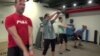 FILE - Exercisers at the Roam Fitness gym in downtown Washington