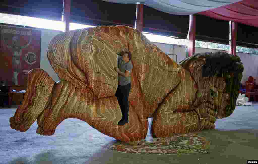 Swiss artist Dave Pflugi shows the shape of his sculpture named 'The Seeds of Victory' in Rio de Janeiro, Brazil.