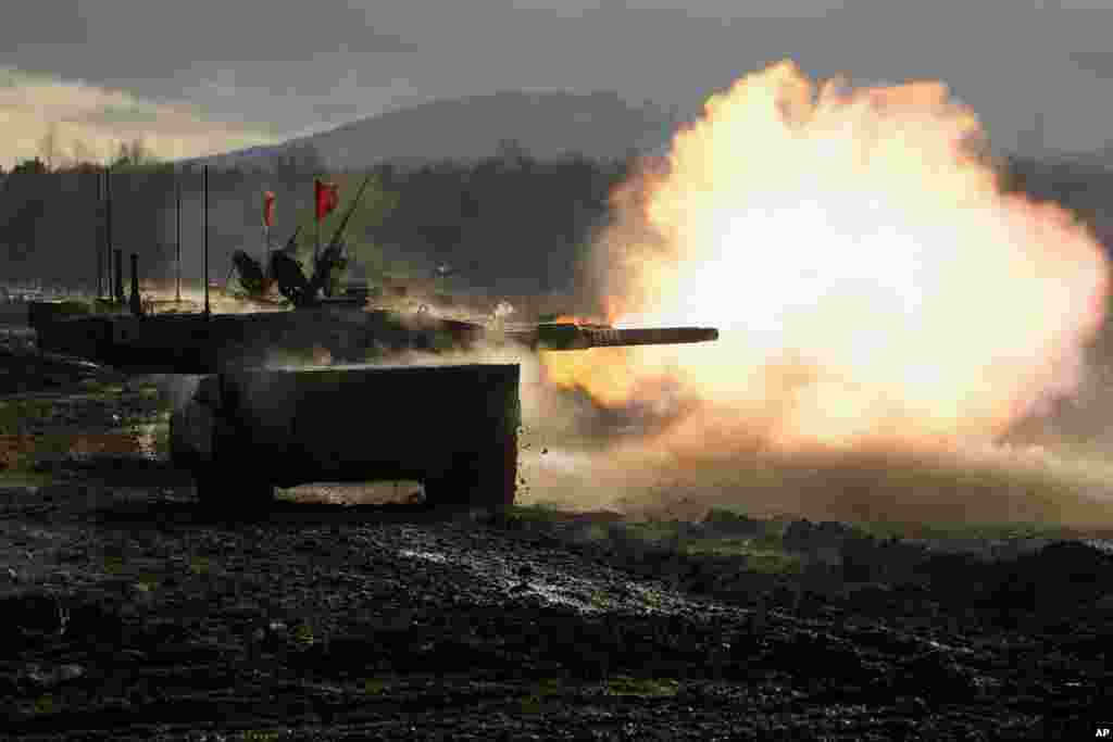 Japanese Ground-Self Defense Force (JGDDF) Type 90 tank fires its gun at a target during a live-fire annual exercise at the Minami Eniwa Camp in Eniwa, on the northern Japan island of Hokkaido.