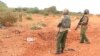 FILE - A Kenyan security officer stands at the scene where a blast killed Kenyan policeman at the Garissa county, eastern Kenya, May 24, 2017.