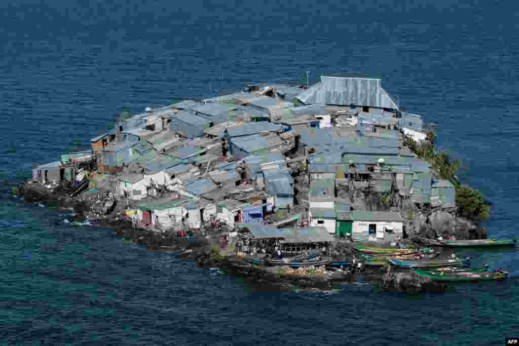 A rounded rocky outcrop covered in metallic shacks, Migingo Island rises out of the waters of Lake Victoria on the border of Uganda and Kenya like an iron-plated turtle. The densely-populated island is barely a quarter of a hectare large, its residents crammed into a hodge-podge of corrugated-iron homes, with seemingly little but a few bars, brothels and a tiny port to boast of.