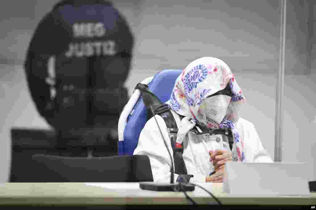 The 96-year-old defendant Irmgard F. sits in an ambulance chair behind a plexiglass screen in a courtroom in Itzehoe, Germany. She is charged of more than 11,000 counts of accessory to murder. Prosecutors argue that she was part of the apparatus that helped the Nazi camp function more than 75 years ago.