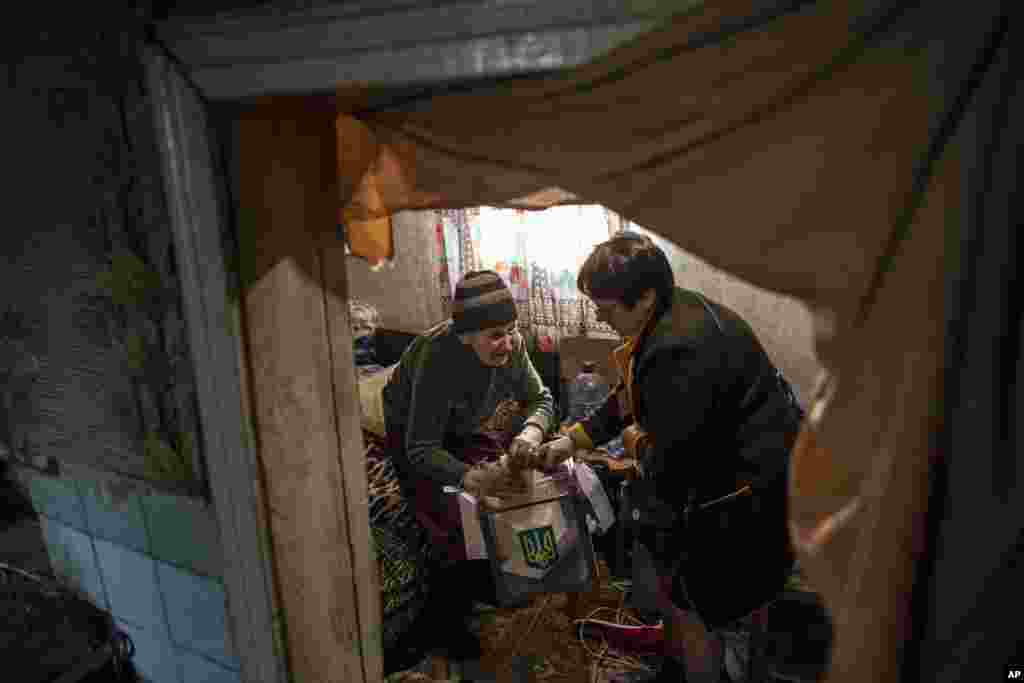 An elderly woman casts her ballot at home during the presidential election in Mariinka, near a contact line not far from Donetsk, eastern Ukraine.