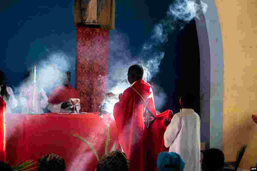 Father Celso Taibo burns incense during a palm Sunday Mass at Lady of Grace Parish Catholic Church in Barrio Manasse, Buzi District, Sofala Province, Mozambique.