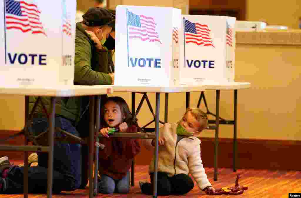People fill out their ballots at a polling center on the Election Day in Jeffersontown, Kentucky, Nov. 3, 2020.