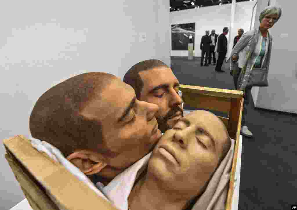 A visitor looks at the artwork 'Strange Fruit' by artist Gil Shachar at the Art Cologne fair in Cologne, Germany.
