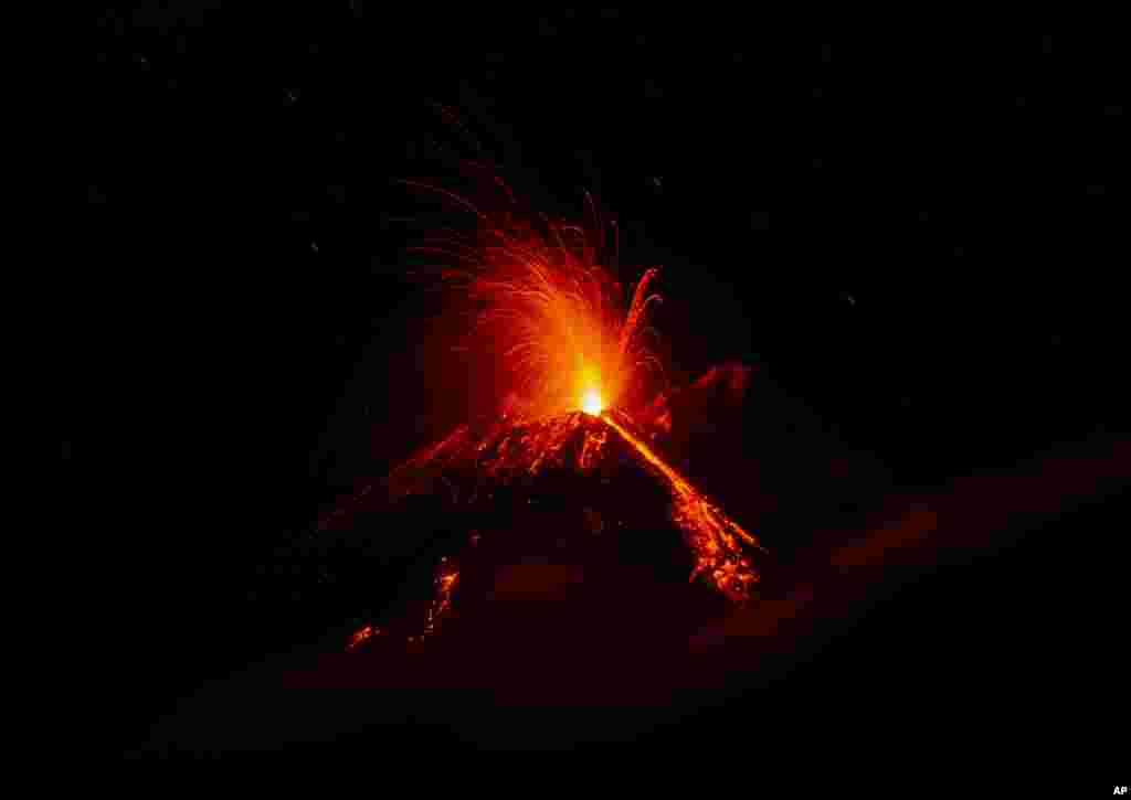 Mount Etna volcano spews lava during an eruption. Dec. 8, 2018. Mount Etna in Sicily has roared back into spectacular volcanic action, sending up plumes of ash and spewing lava.