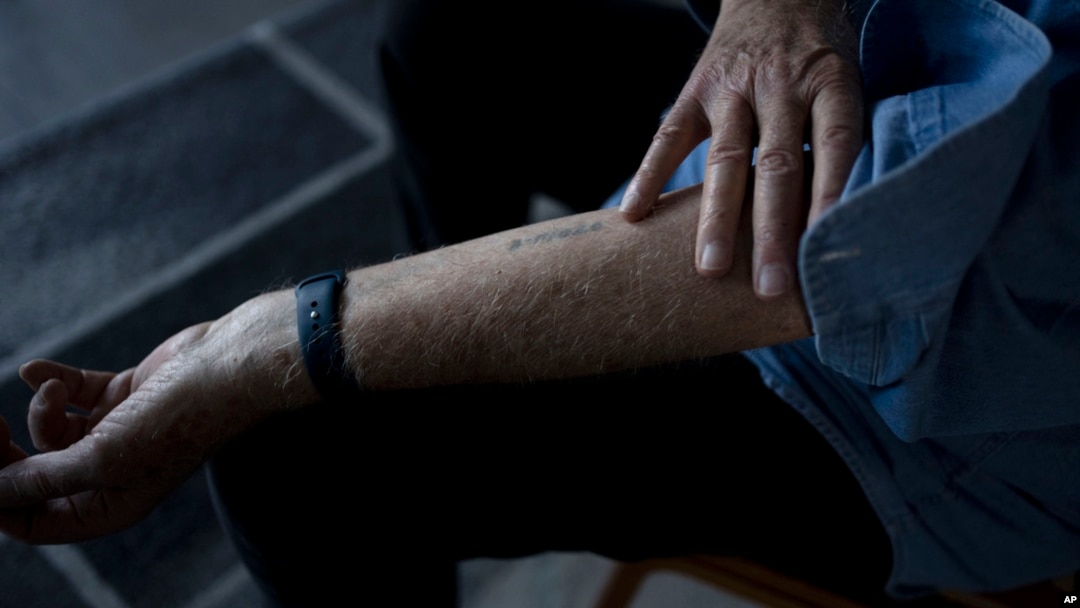 FILE - At his home in Haifa, Israel, Holocaust survivor Naftali Fürst shows the numbers that were tattooed on his arm when he was imprisoned at Auschwitz, Jan. 14, 2025.