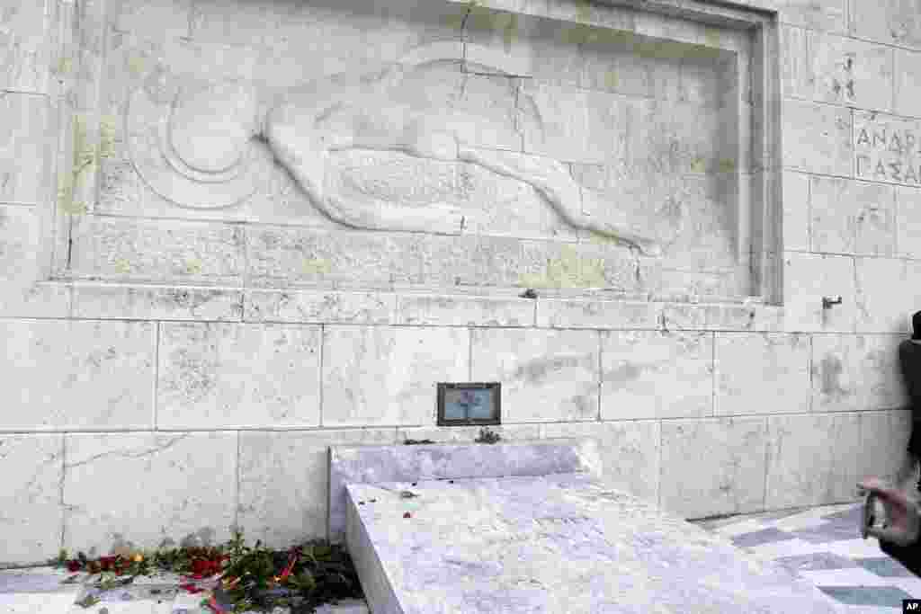 A wreath laid earlier by visiting German Chancellor Angela Merkel at the Tomb of the Unknown Soldier in Athens lies on the ground after being destroyed by protesting state schoolteachers in Greece.