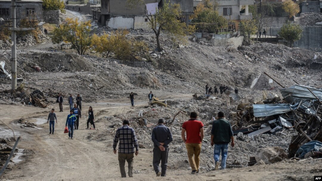 FILE - People arrive in Sirnak city on Nov. 14, 2016, after a 246-day curfew was partially lifted. The curfew in Sirnak, a city of 290,000, was imposed on March 14 as part of operations to eradicate the PKK from eastern Turkey.