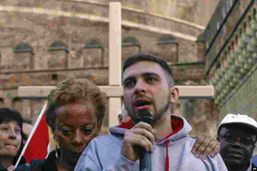 Sex abuse survivor Alessandro Battaglia, right, is hugged by survivor and founding member of the ECA (Ending Clergy Abuse), Denise Buchanan, as he speaks during a twilight vigil prayer near Castle Sant' Angelo, in Rome, Italy. Pope Francis opened a landmark sex abuse prevention summit by warning senior Catholic figures that the faithful are demanding concrete action against predator priests and not just words of condemnation.