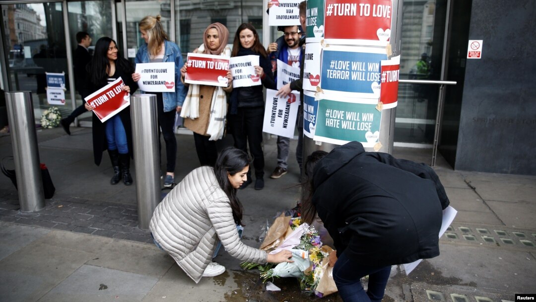 People lay flowers outside New Zealand House, following the Christchurch mosque attacks in New Zealand, in London, March 15, 2019.