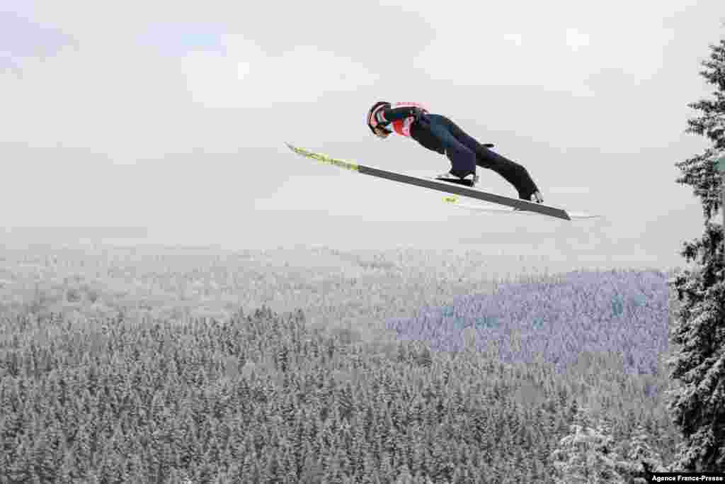 Austria's Daniel Huber soars through the air during the FIS Men's Ski Jumping World Cup in Klingenthal, eastern Germany, Dec. 11, 2021.