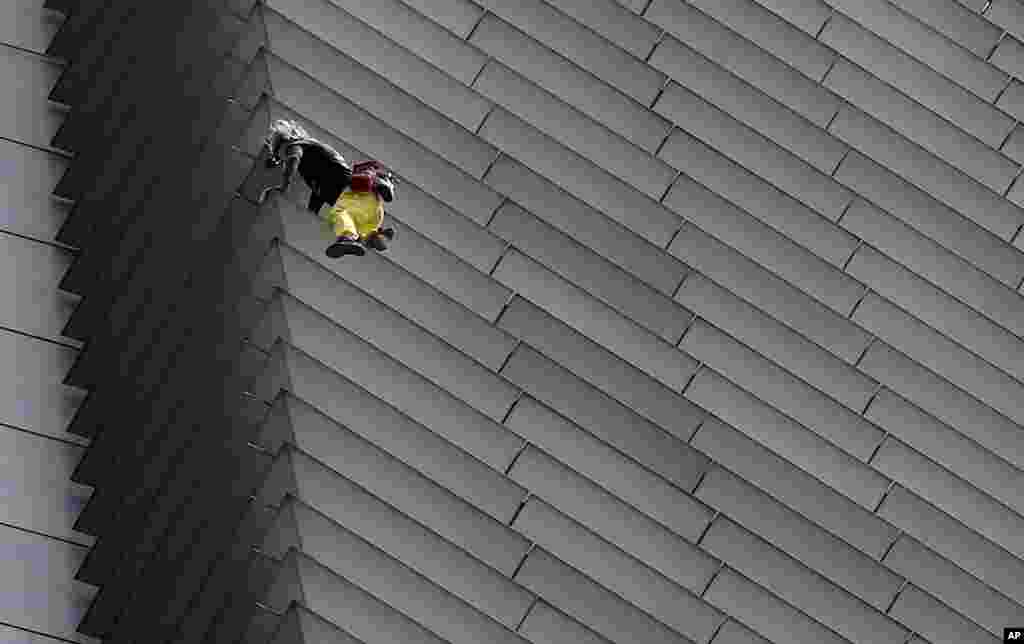 French urban climber Alaine Robert, popularly known as "Spiderman", climbs the 47-Storey GT Tower Building at the financial district of Makati city east of Manila, Philippines.