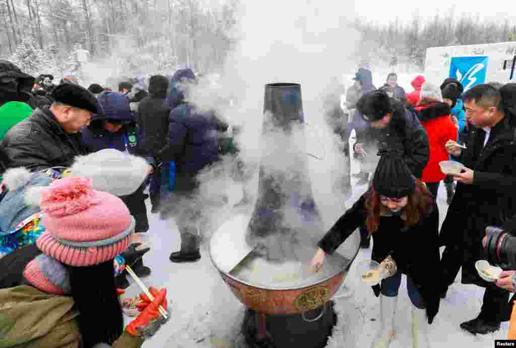 Visitors enjoy a hotpot in subzero temperatures at the opening ceremony of a "Pole of Cold" festival in Genhe, Inner Mongolia, China, Dec. 25, 2018.