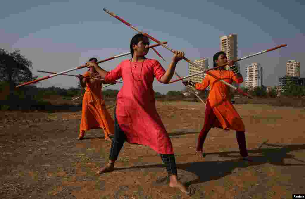 Women practice Shivkalin Yudha Kala, a Maharashtrian martial art on the eve of International Women's Day, at a ground on the outskirts of Mumbai, India.