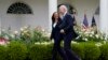 FILE - President Joe Biden walks with Vice President Kamala Harris after speaking on updated guidance on face mask mandates and COVID-19 response, in the Rose Garden of the White House, May 13, 2021, in Washington.
