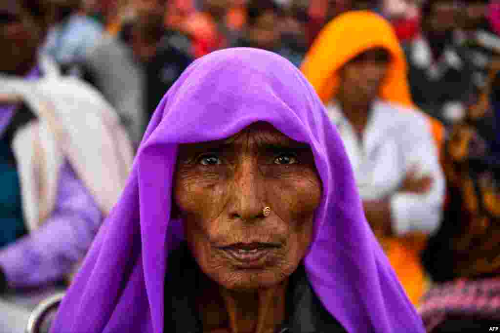 An Indian participant in the 'Dignity March' looks on as she attends the culmination of the march at Ramleela Ground in New Delhi.