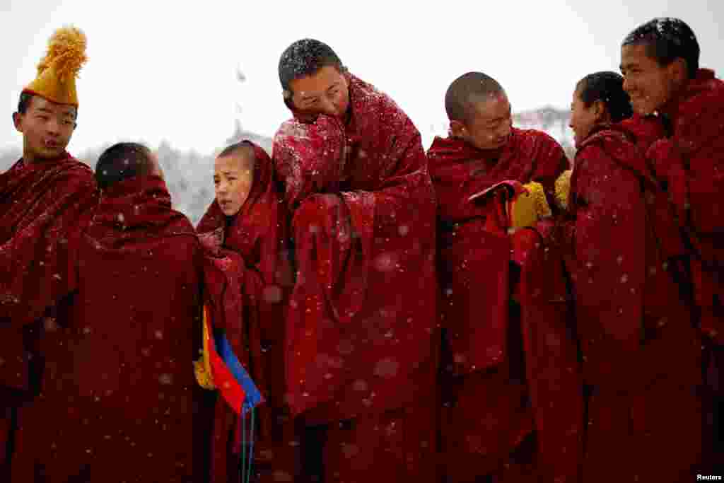 Tibetan monks attend a ceremony at the Langmu Lamasery during the "Sunbathing Buddha Festival", in Gannan Tibetan Autonomous Prefecture, Gansu Province, China, Feb. 17, 2019.