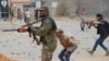 Fighters loyal to Libya's U.N.-backed government (GNA) fire weapons during a clash with forces loyal to Khalifa Haftar at the outskirts of Tripoli, Libya, May 21, 2019. 